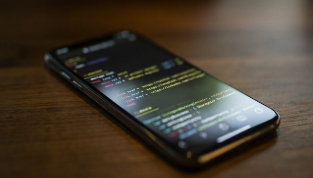 Smartphone displaying a web app on a desk